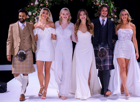 Group of men in kilts and women in wedding dresses standing next to each other 